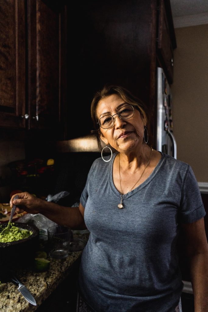 woman in her kitchen making guacamole